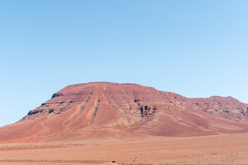 Fototapeta na wymiar Red, rocky Namib desert landscape near Springbokwasser