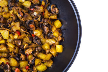 Frying pan with fried zucchini, mushrooms on white background