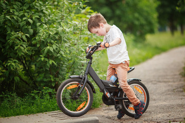 Fototapeta premium the boy is riding a bike on the street