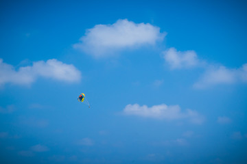 Parasailing high up in the blue sky 