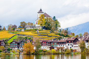 Traditional houses, church. Switzerland. Beautiful Alpine landscape with church and typical Swiss houses at autumn  day