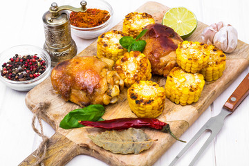 Cajun chicken and corn grilled on wooden board