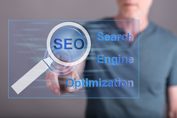 Man touching a seo concept on a touch screen