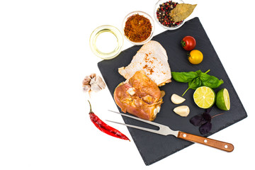 Plate with chunks of fresh chicken and seasonings