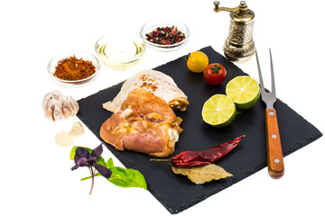 Plate with chunks of fresh chicken and seasonings