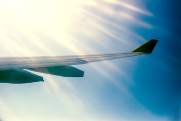 Wing aircraft against the sky in the sunlight