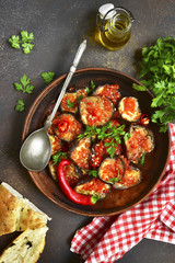 Eggplant slices in a spicy red sauce.Top view. © lilechka75