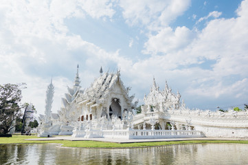 Wat Rong Khun (White Temple) - art exhibit in the style of a Buddhist temple in Chiang Rai Province, Thailand - obrazy, fototapety, plakaty