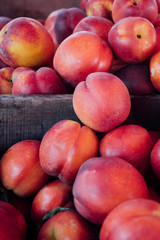 Yellow Summer Stone Fruit Organic Locally Grown Nectarines at the Farmer's Market in a Wooden Crate