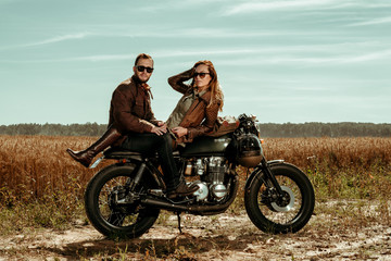 Fototapeta na wymiar Couple and cafe racer motorcycle