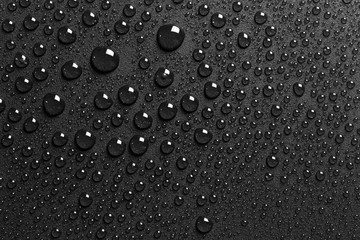 Water drops on rough black surface