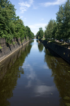 Kronstadt, Ruusia - July 16, 2014. A canal with green trees in Kronstadt. Kronstadt is city-fortress in the Baltic