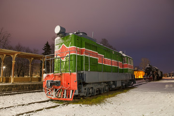 Fototapeta na wymiar Old train at vintage station. Winter time.