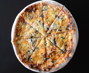 fresh baked italian pizza,black background, top view
