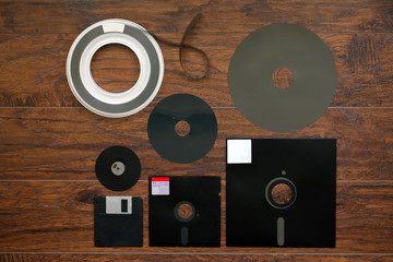 The old 8-inch 5.25-inch, 3.5-inch floppy disk, magnetic tape for an old IBM computer, a comparison...