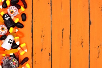 Halloween candy side border over an old orange wood background