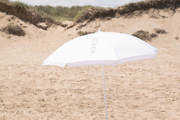 White parasol on the beach.