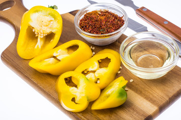Yellow sweet pepper, slices cut, on kitchen wooden cutting board