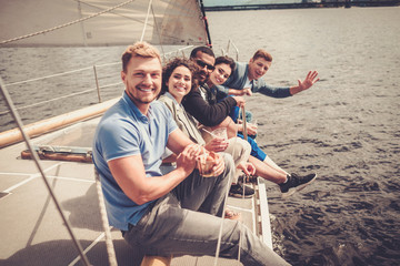 Happy friends resting on a yacht