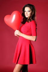 Pretty girl in a red dress celebrating Valentine's day.