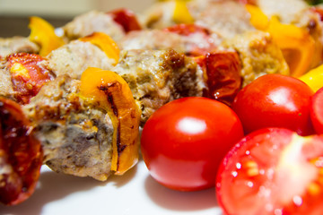 Kebab with vegetables. Meat with tomatoes and peppers on bamboo skewers.