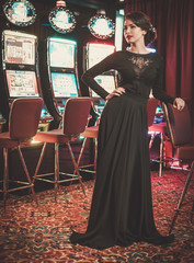Beautiful woman near slots machines in a luxury casino interior