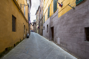 Narrow medieval street in Siena, Italy