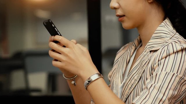 Asian teenager woman joyfull when chatting with smartphone