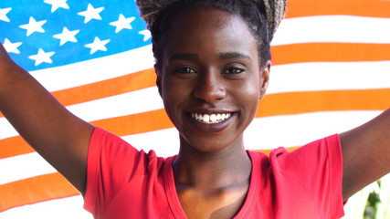 American Young Black Woman Celebrating with USA Flag