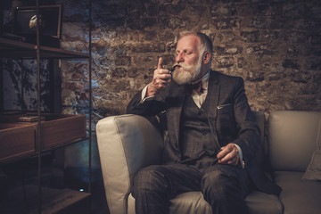 Senior man with a smoking pipe