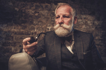 Senior man with a smoking pipe