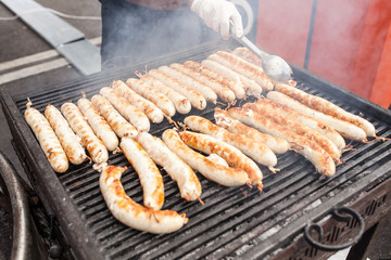 BBQ with fiery sausages on the grill