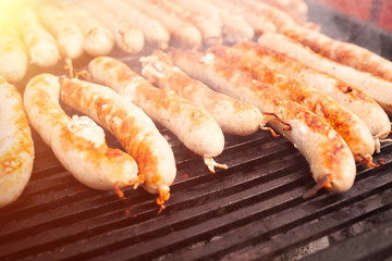 BBQ with fiery sausages on the grill
