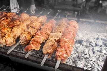 Grilled kebab cooking on metal skewer. Roasted meat cooked at barbecue. BBQ fresh beef meat chop slices. Traditional eastern dish, shish kebab.