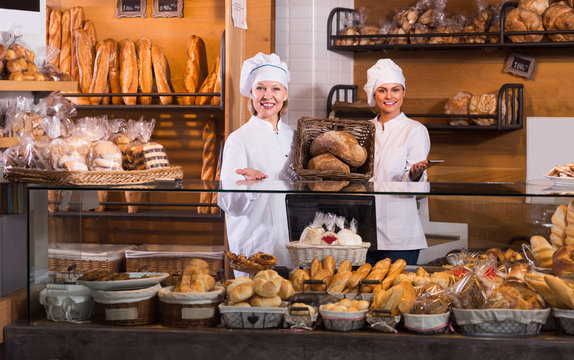 Bakery staff offering bread