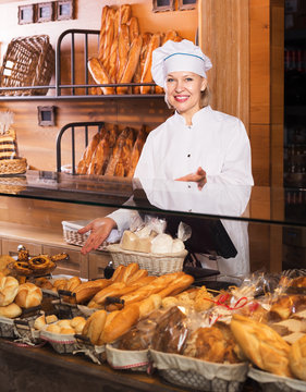 Bakery employee offering bread