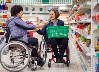 Obraz premium Two disabled women in a department store