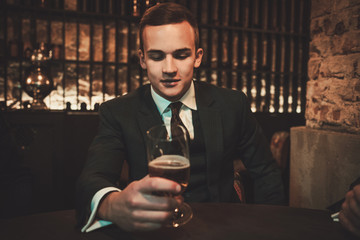 Young gentleman tasting craft beer