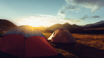 Fototapeta na wymiar Tents During Beautiful Sunrise Near The Mount Elbrus In Russia