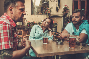 Good old friends drinking beer in a pub