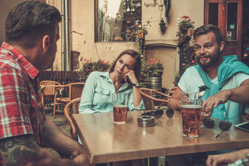 Good old friends drinking beer in a pub