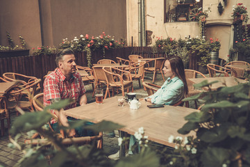 Couple relaxing in pub's yard