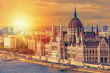 Travel and european tourism concept. Parliament and riverside in Budapest Hungary with sightseeing ships during summer day sunset. - obrazy, fototapety, plakaty