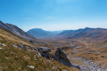 A high mountain range with peaks and plateaus on a warm summer day