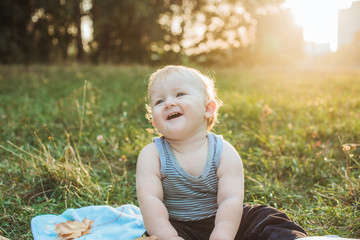 Little adorable baby boy at sunset summer portrait