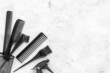 styling hair with combs and tools in barbershop on stone background top view mock-up