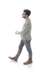 Naklejka premium side view. modern young man confidently goes forward.