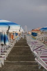 Beach with parasols and sun loungers in Italy