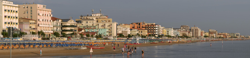 Panoramic view of the beach and bathing establishments of the Romagna Riviera at dawn.