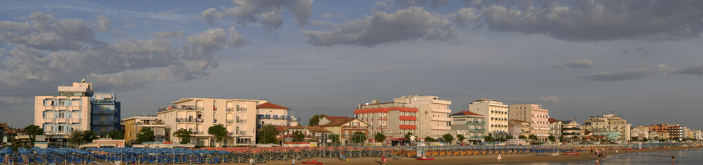 Panoramic view of the beach and bathing establishments of the Romagna Riviera at dawn.